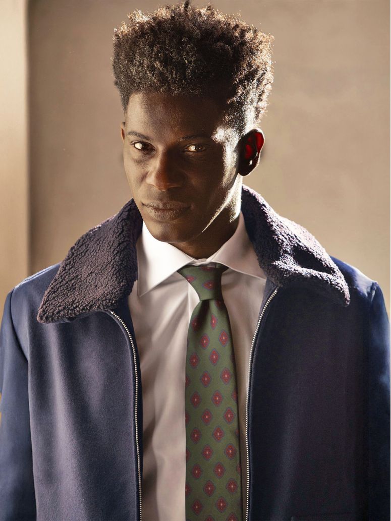 Green silk tie with retro motifs